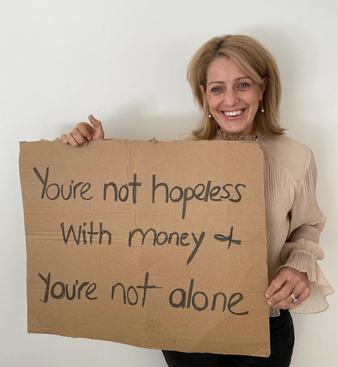 woman holding up cardboard sign