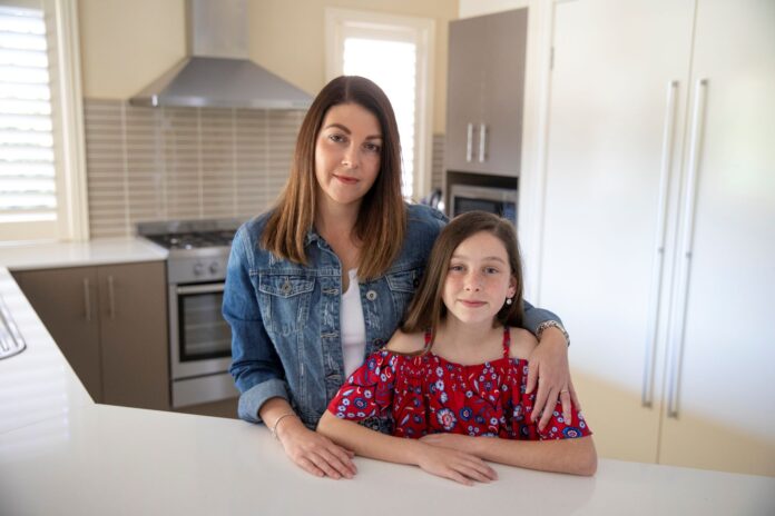 Rebecca Hatton in her home at Floraville with daughter Chloe