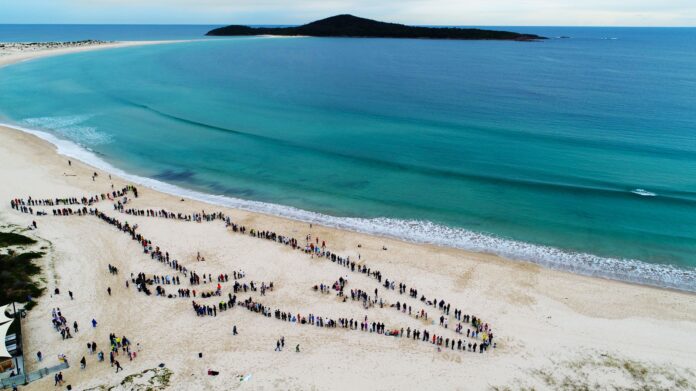 A total of 1,318 people formed a Human Whale at Fingal Beach in 2018.