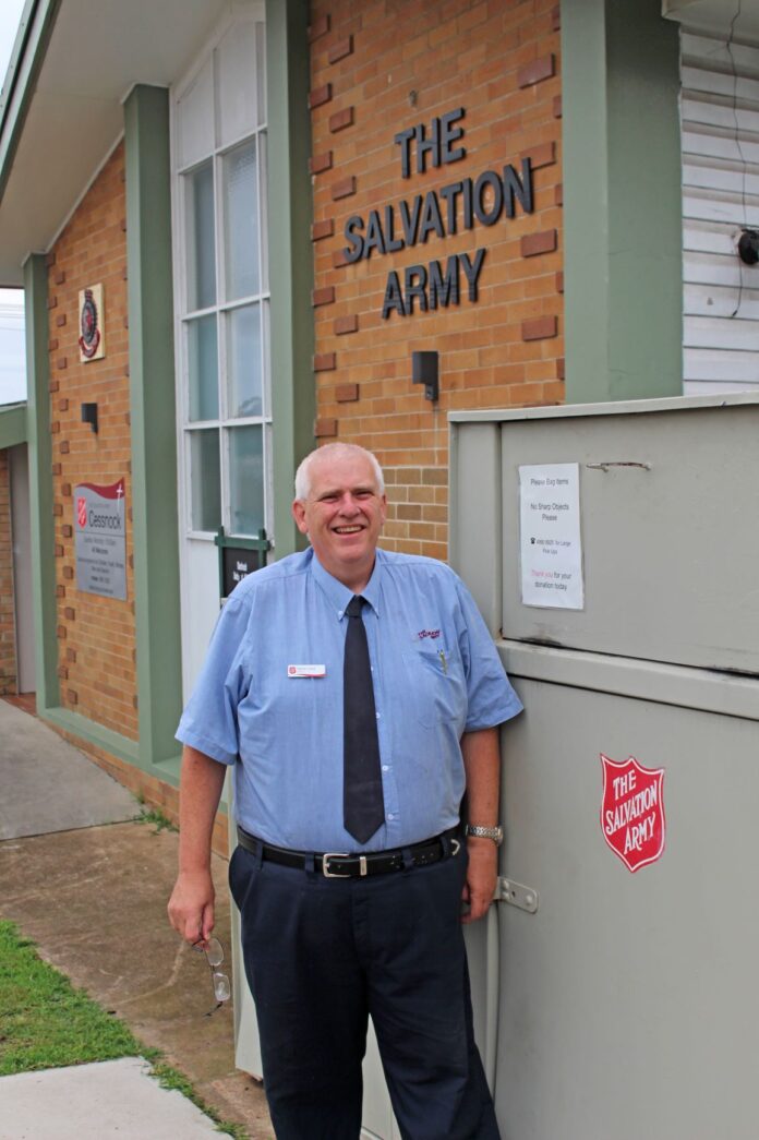 The Salvation Army’s local captain, Darryn Lloyd, stands next to donation bins in Cessnock.