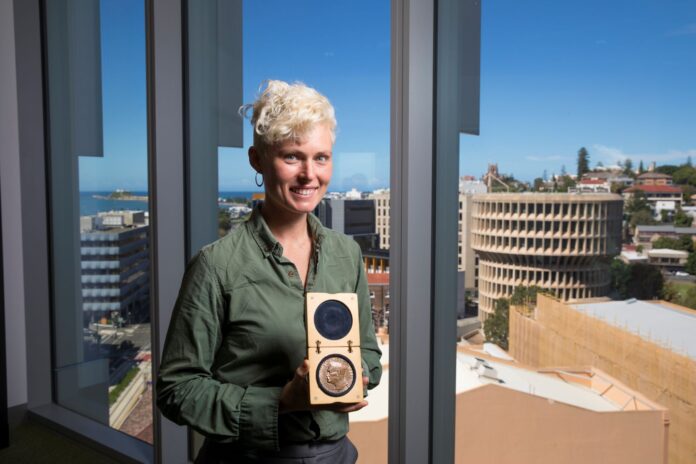 woman holding an award