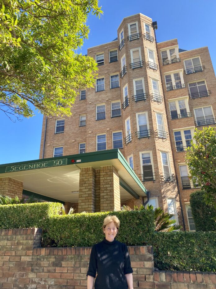 Parliamentary Secretary Cusack in front of Segenhoe Flats