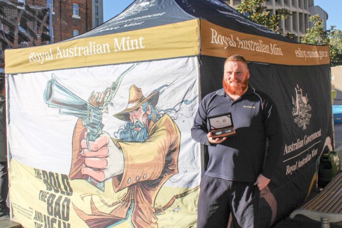 man holding box of special coins