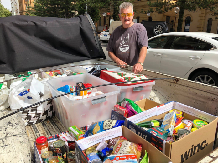 Soul Café volunteer Steve Poulton collects rescued food in the ute.