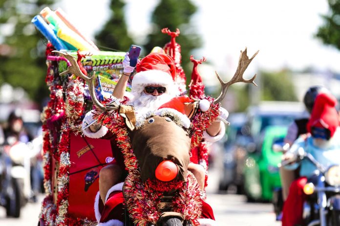 santa riding motorcylce which is dressed up like rudolph