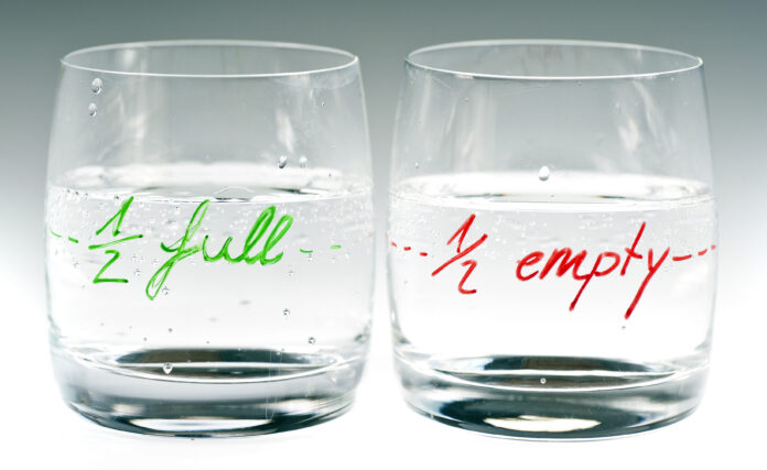 one glass saying half full and another saying half empty