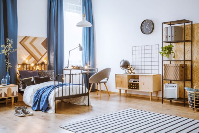 large bedroom with bed, drawers and desk