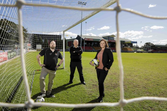 three people in soccer goal