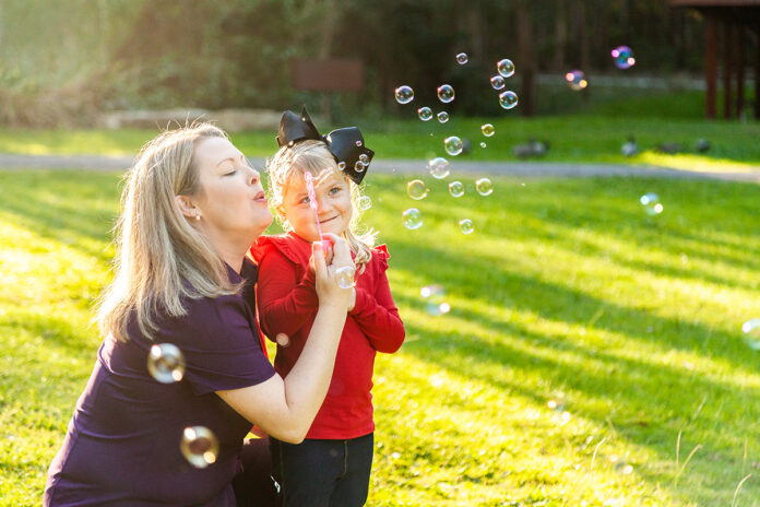 mum and daughter blowing bubbles