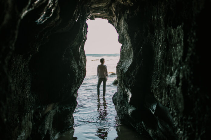 woman in water between rocks