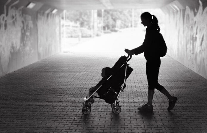 Woman walking with her son in the city