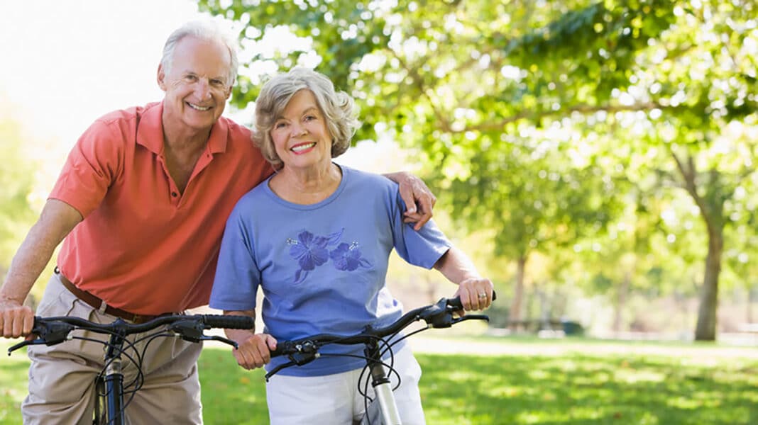 two elderly people on bikes