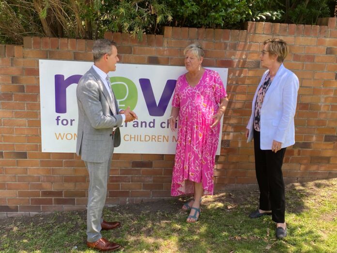 three people speaking outside
