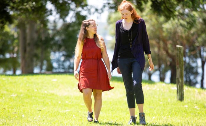 two women walking in a park