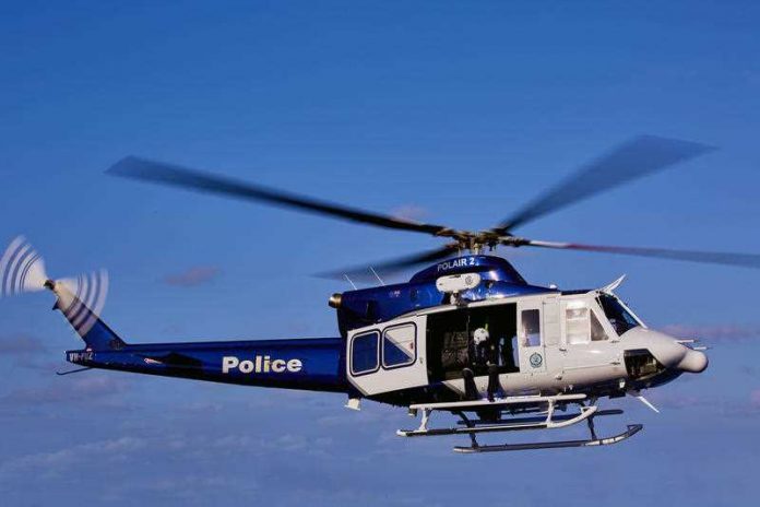 blue and white police helicopter in the sky