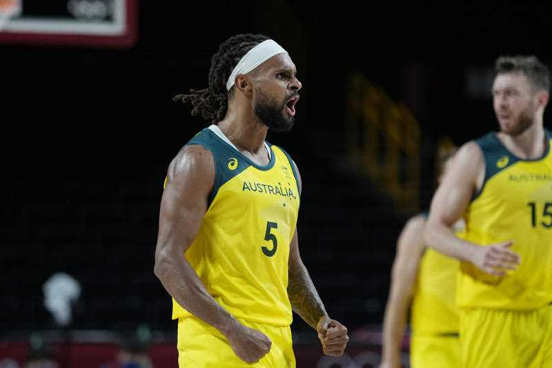 Australia's Patty Mills (5) celebrates after a score against Germany during a men's basketball preliminary round game at the 2020 Summer Olympic