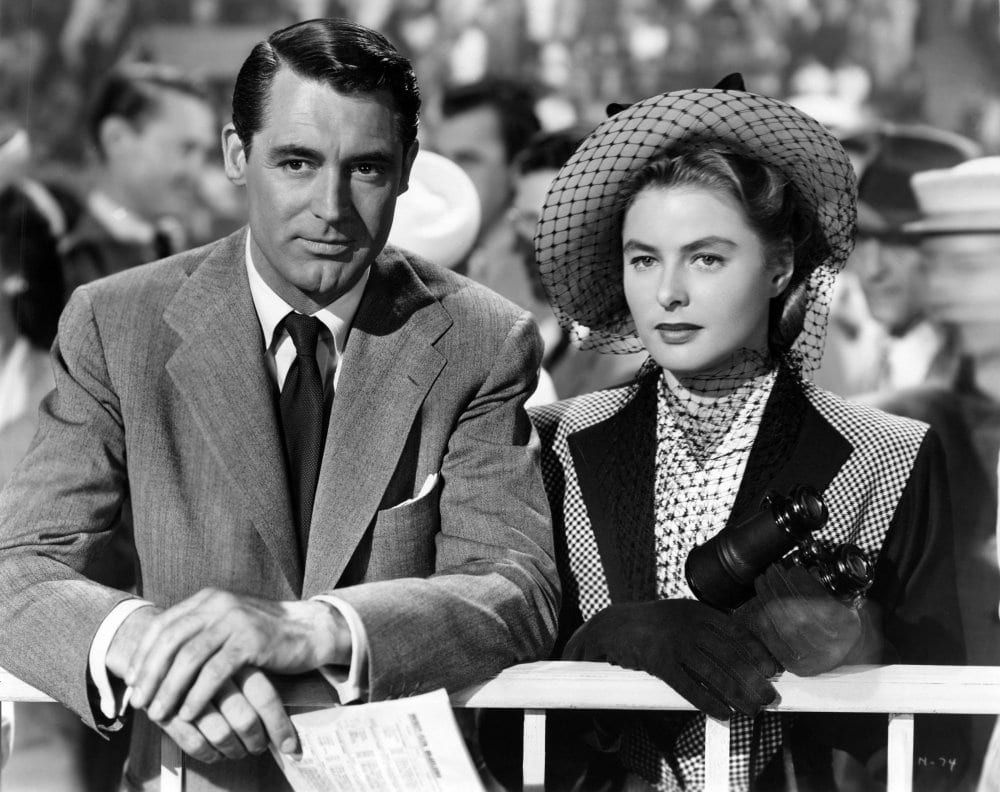 black and white shot of Hollywood legends Cary Grant and Ingrid Bergman at the horse racing track