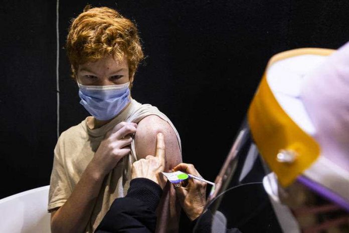 15 year old Jack Guganovic receives a vaccination at the pop-up vaccination clinic at Casey Fields in Melbourne, Saturday, October 16, 2021.