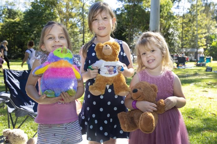 Three children holding teddy bears
